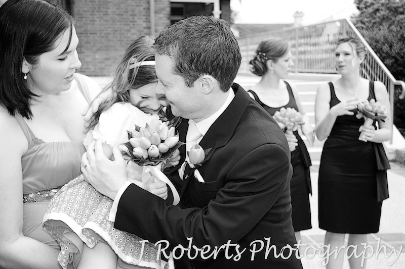 Flower girl hugging groom - wedding photography sydney